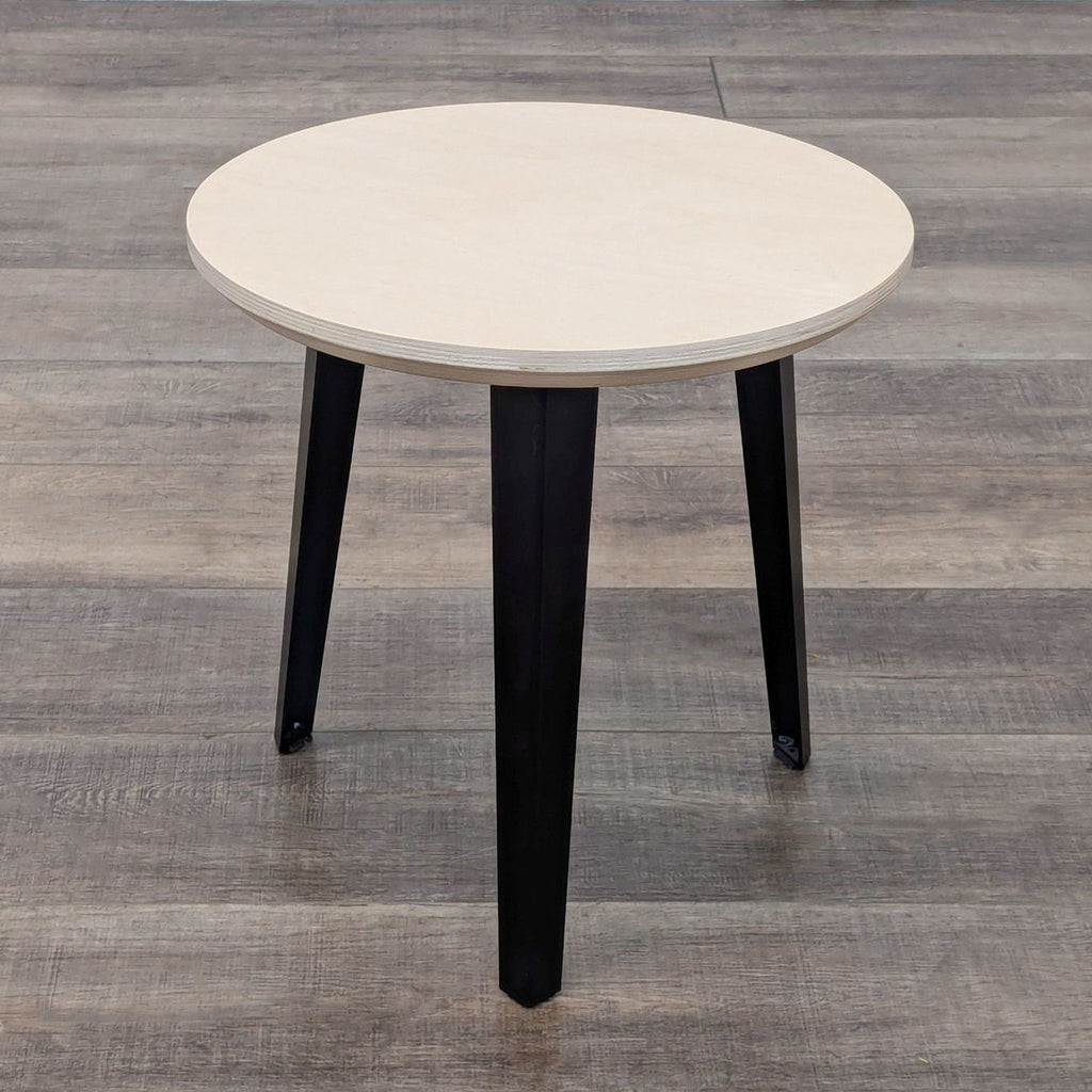 a small table with a black base.