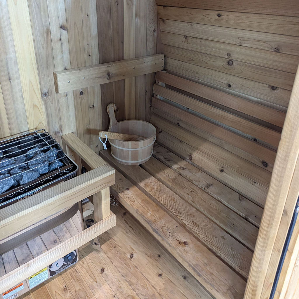 a sauna with a hot tub and a bucket.