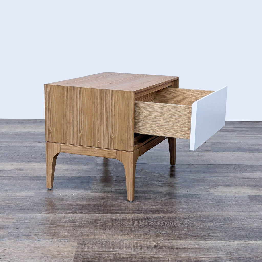 the side table is made of solid wood with a white drawer.