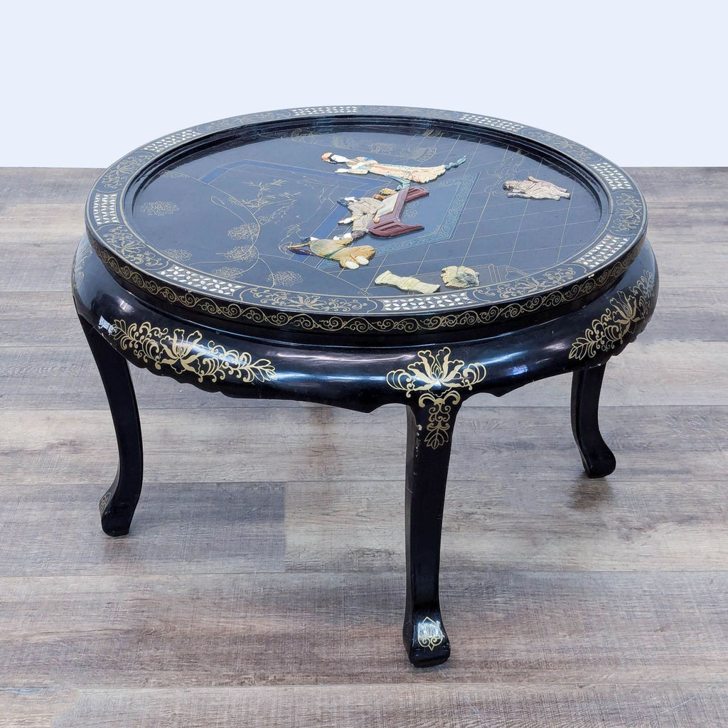 a chinese black lacquer table with a gold and black lacquer top.