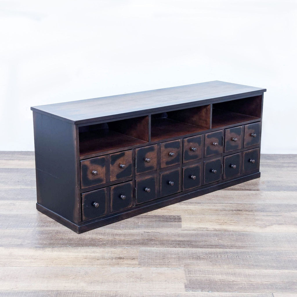 a large, dark brown, three - drawered storage cabinet.