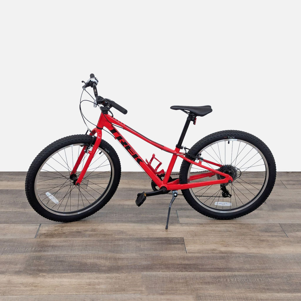 a red bike with a black seat and a red seat.