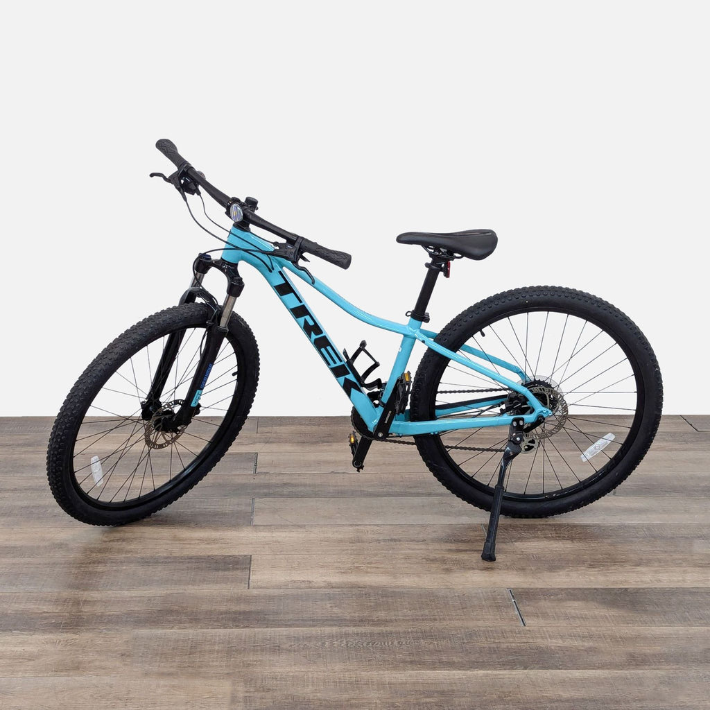 the new mountain bike is a light blue with a black frame and a black seat.