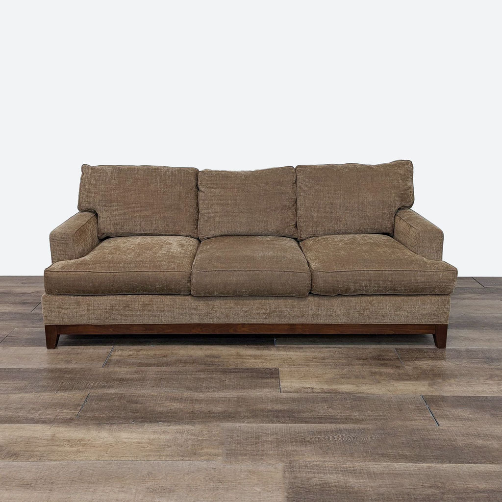 a brown sofa with a brown cushion.