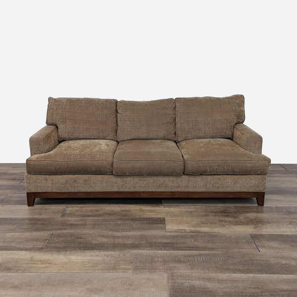 a brown sofa with a brown cushion.