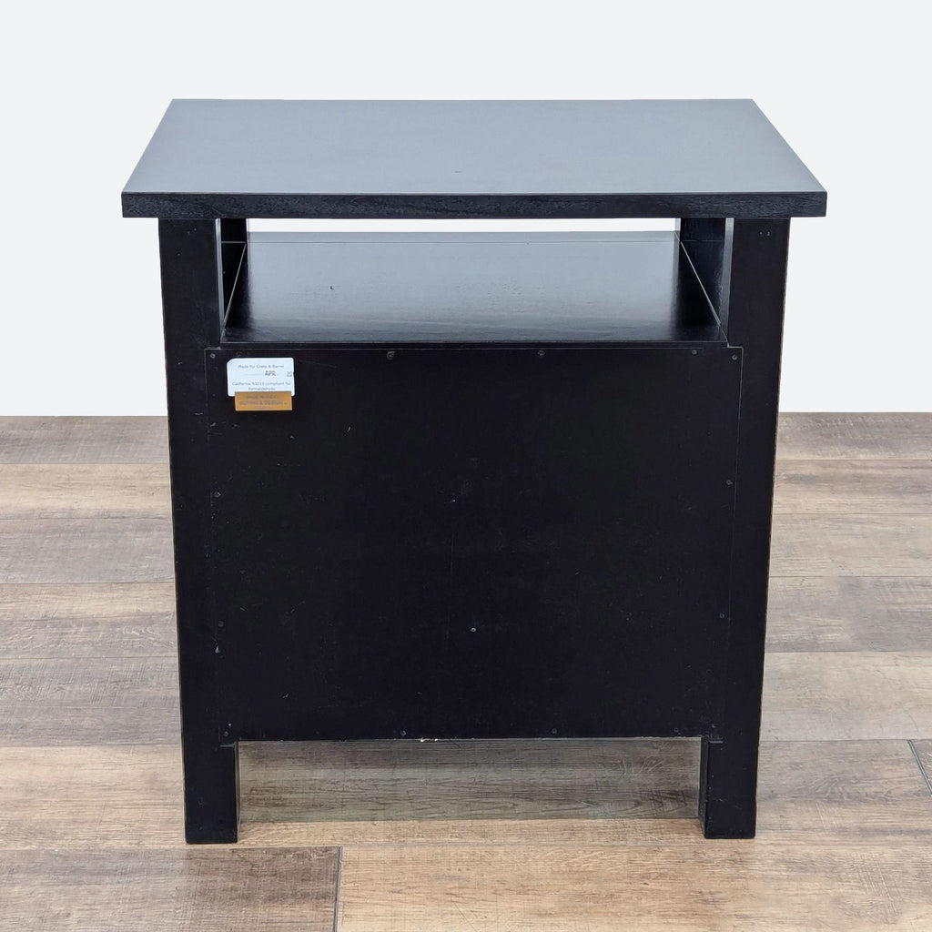 a vintage black metal table with a metal top.