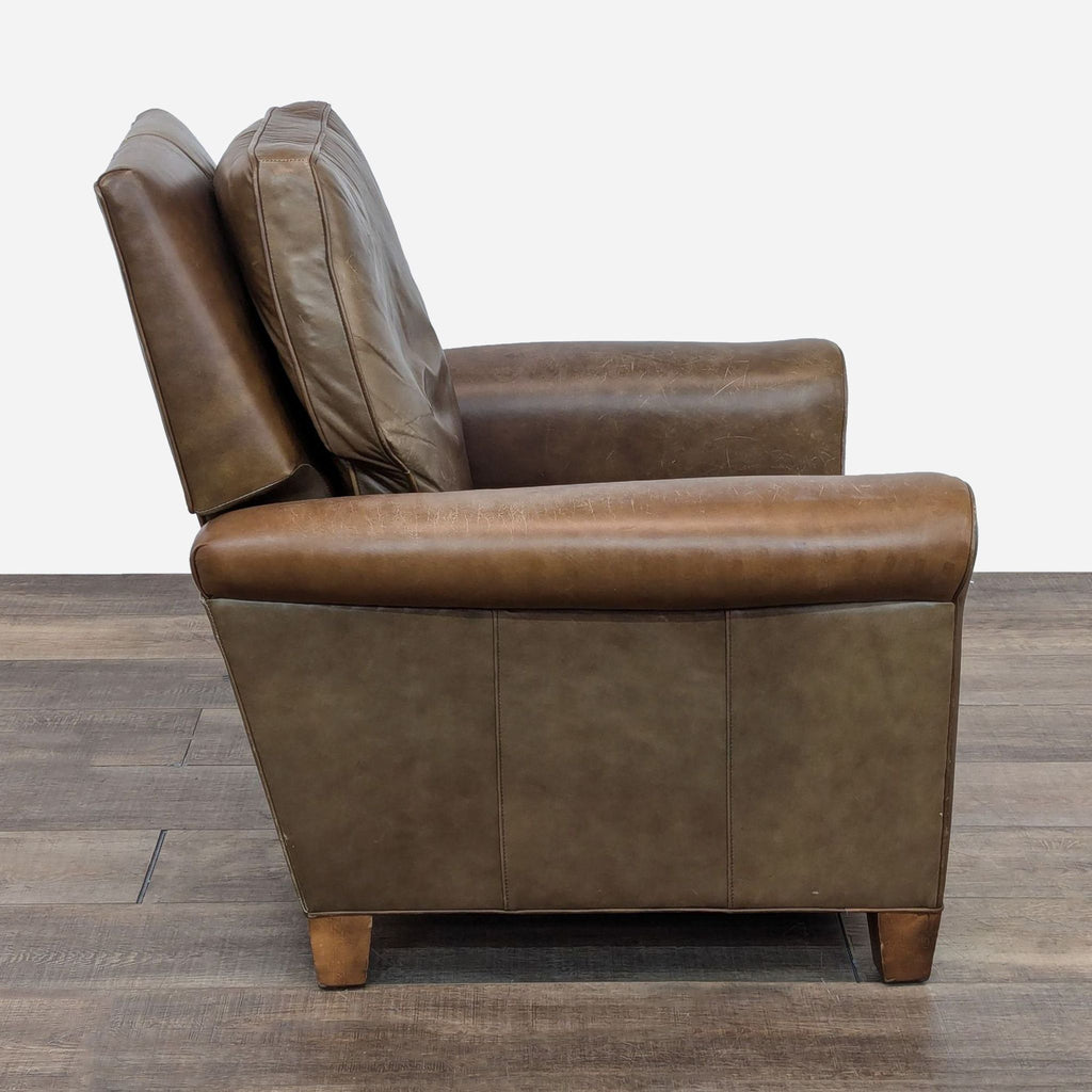 a leather recliner chair with a cushion