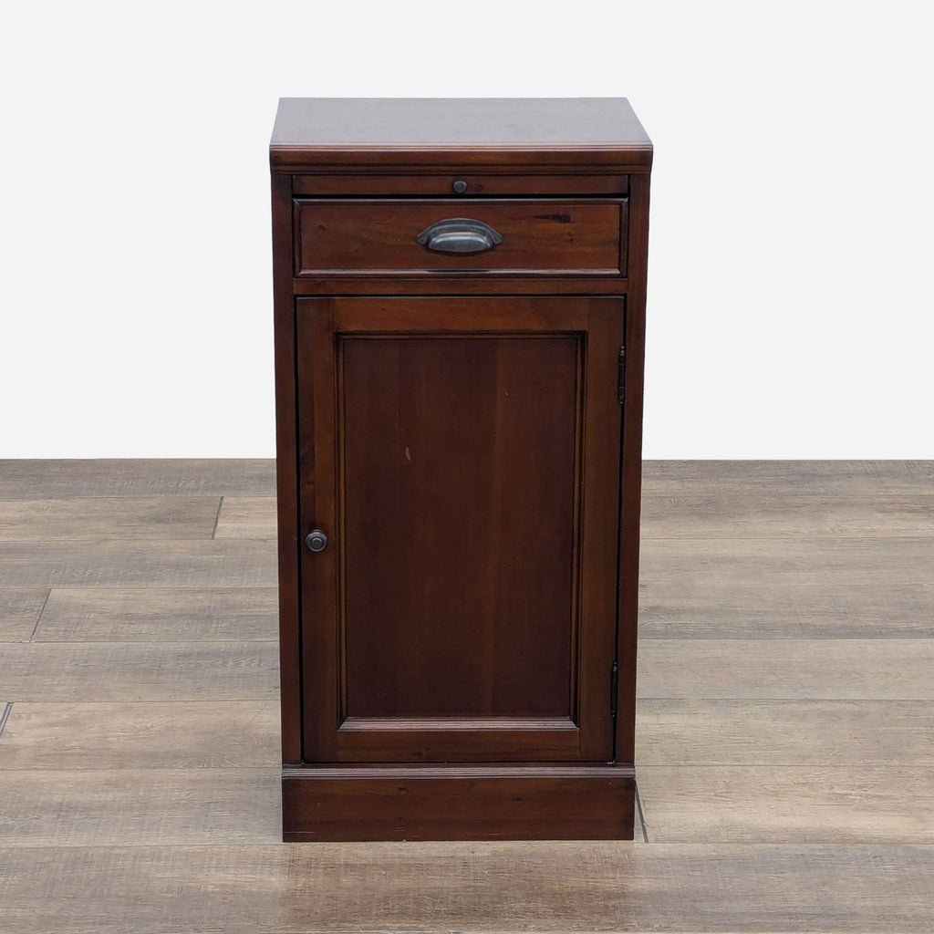 a dark cherry wood cabinet with a metal drawer