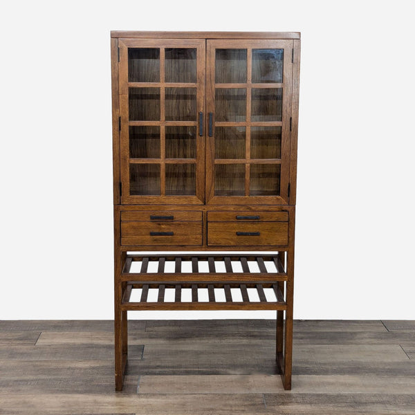 a tall, solid wood cabinet with a glass door and a metal shelf.