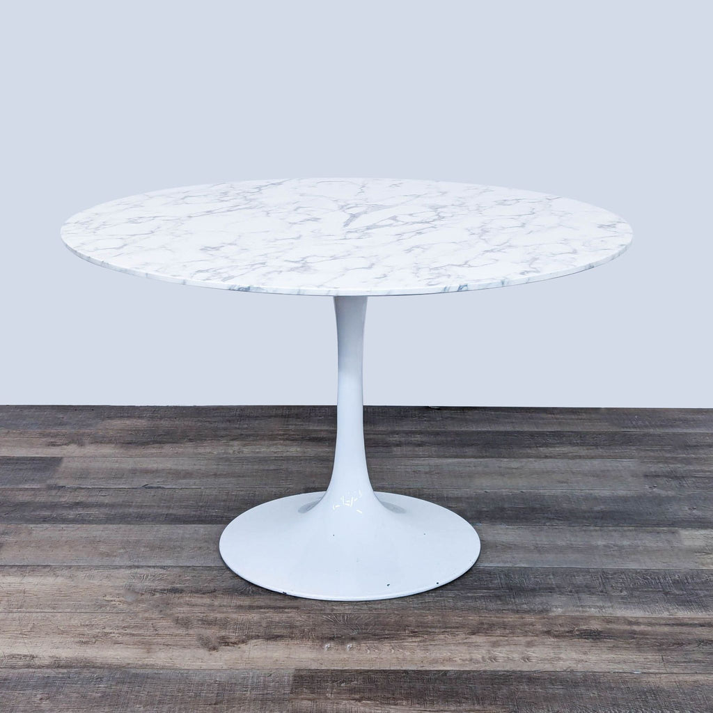 a white marble table with a white base and a black base.