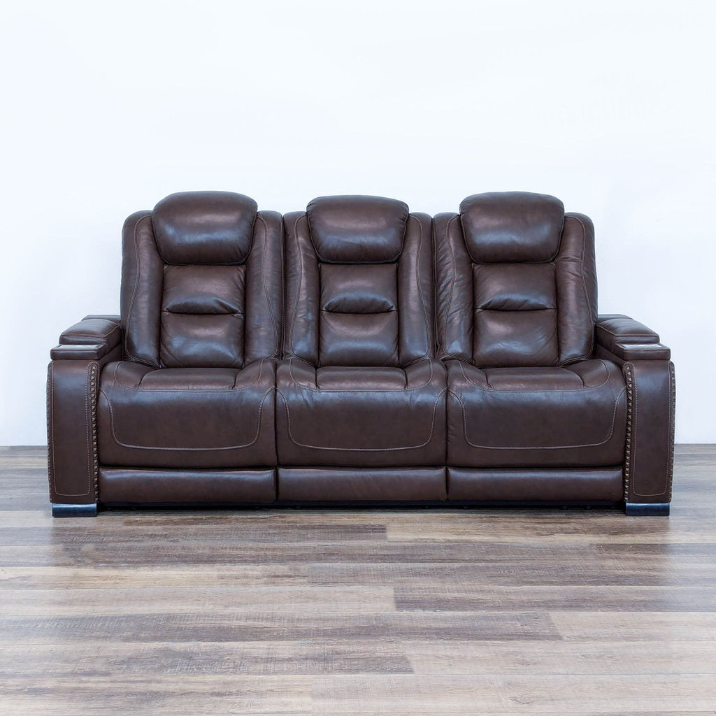 a large brown leather recliner sofa with two backrests.