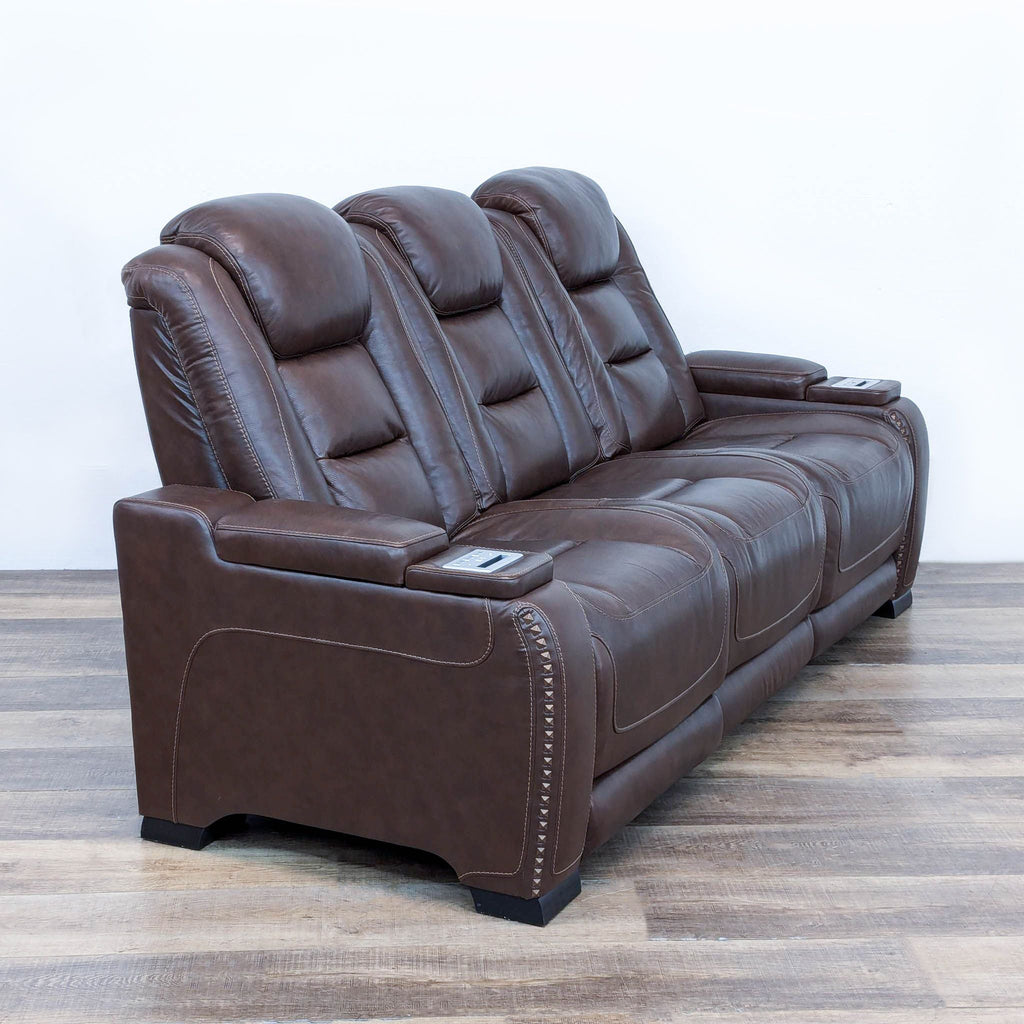 the back of the recliner is a brown leather recliner.