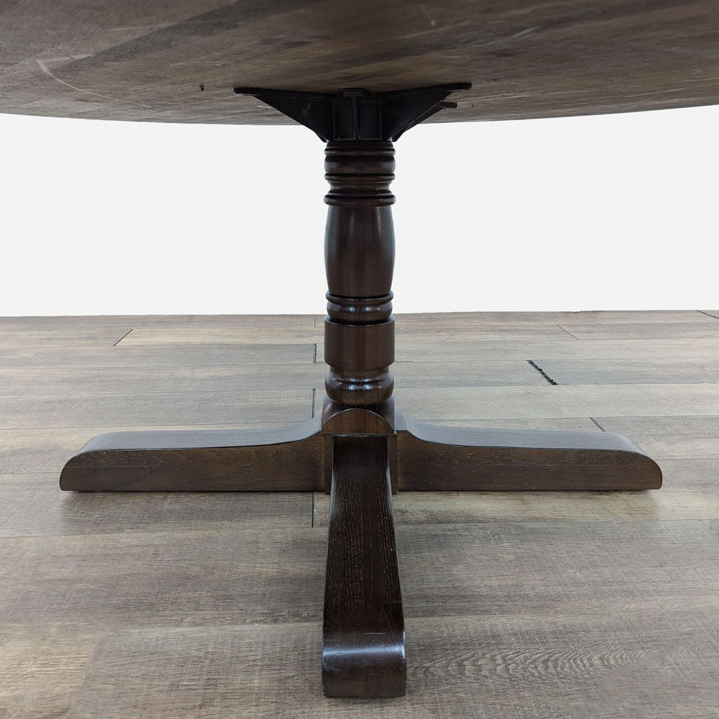 a large italian walnut dining table with a round top and a round top.