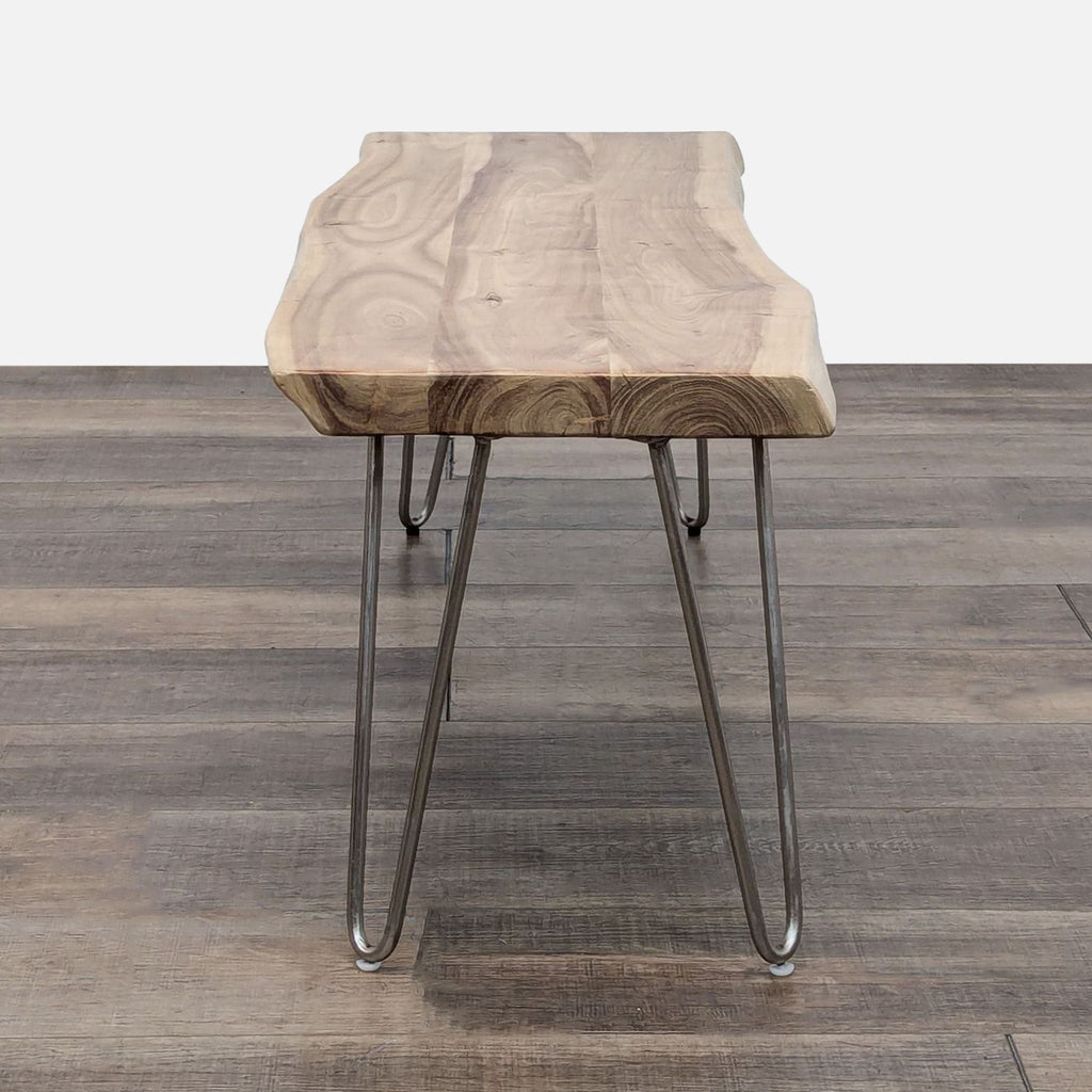 a small, modern stool with a natural wood top.