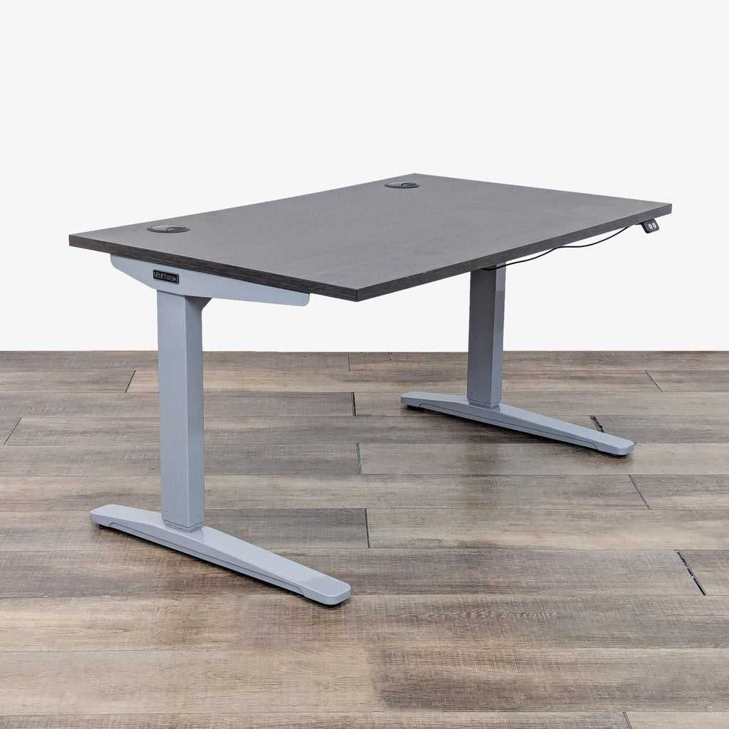 a standing desk with a gray desk top and a gray desk top.