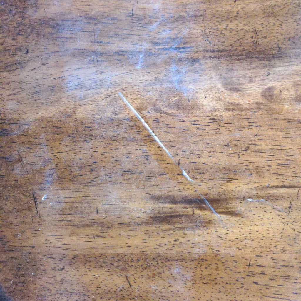 a close up of a table with a scratch on it