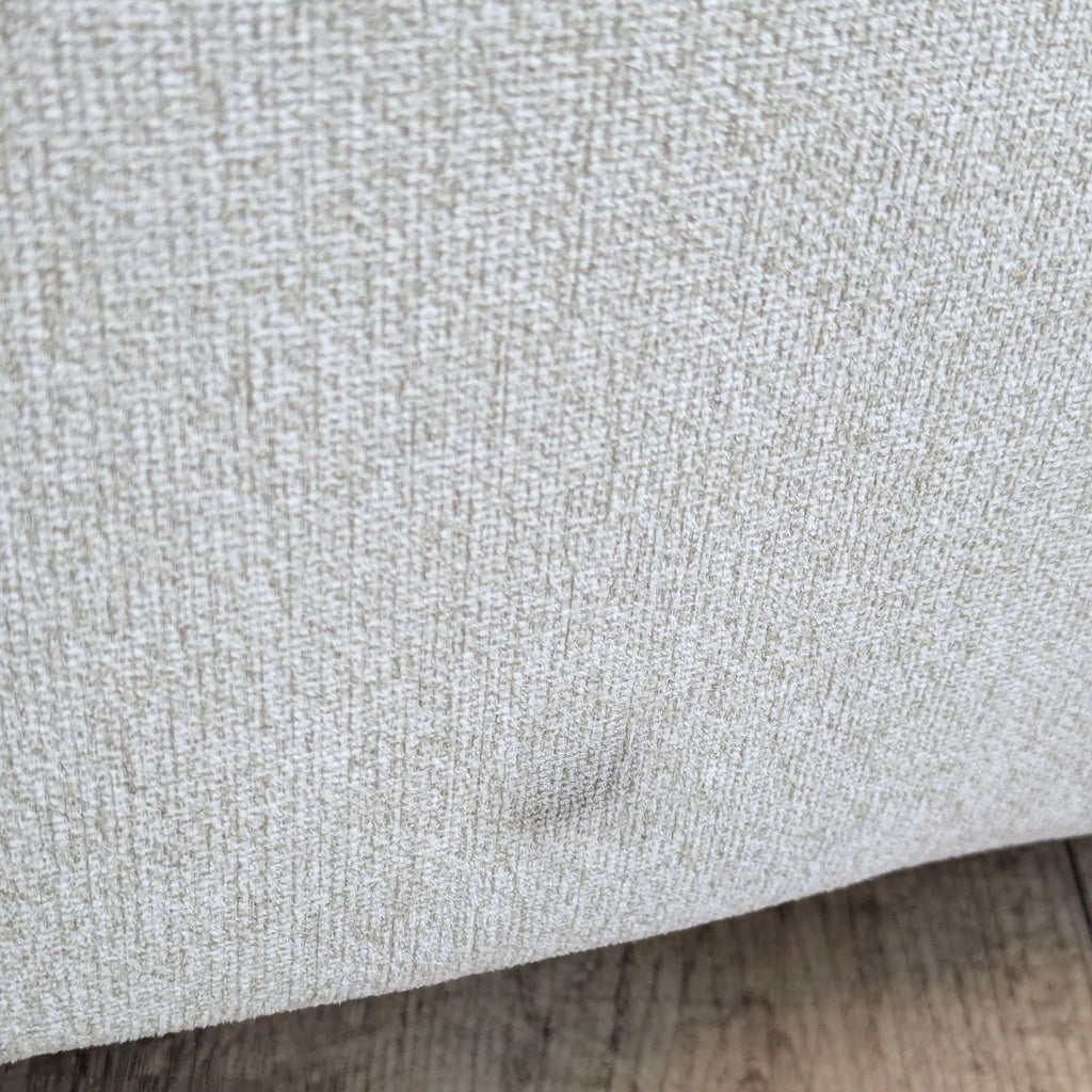 a close up of a white and grey sofa.