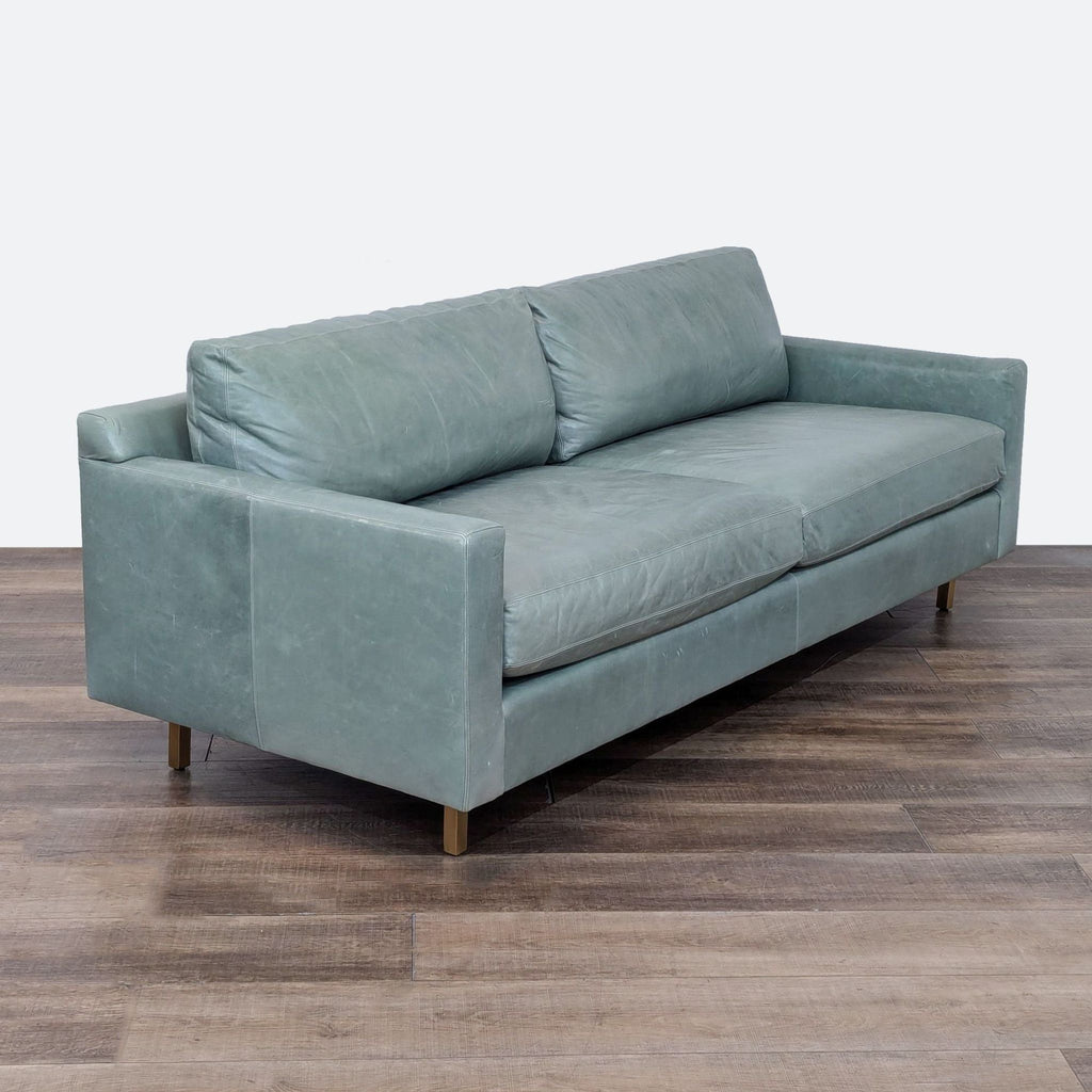 sofa is a modern sofa that is made of soft fabric and has a soft, comfortable seat.