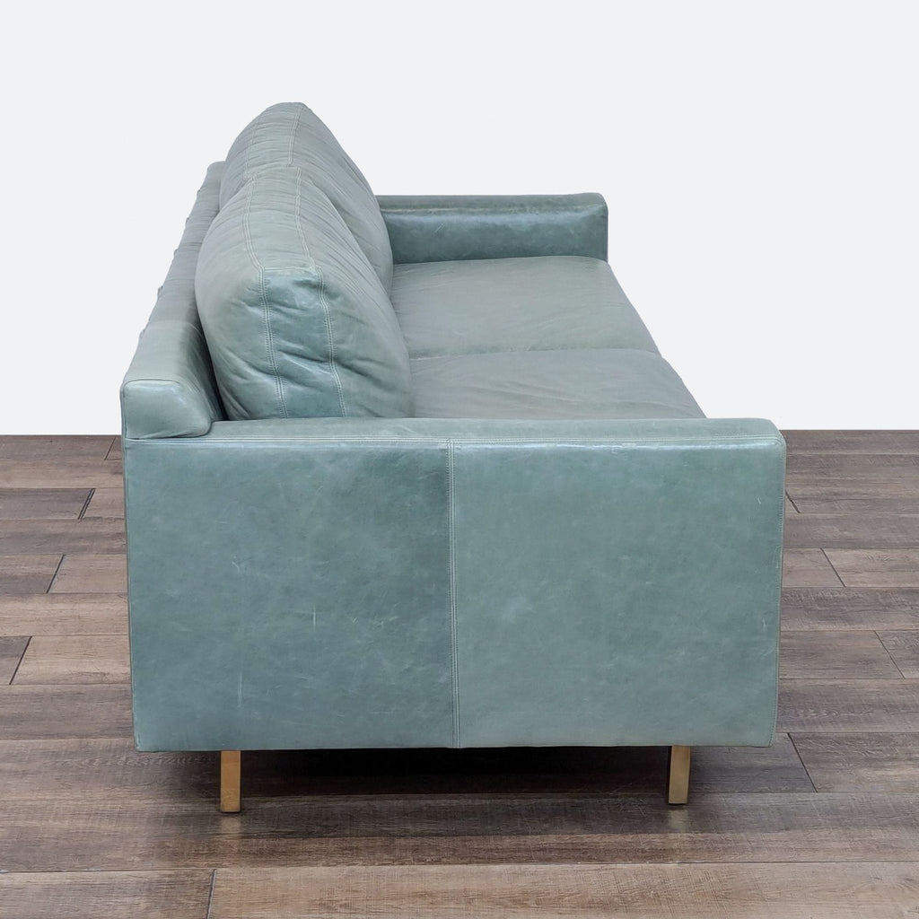 a pair of blue velvet sofas