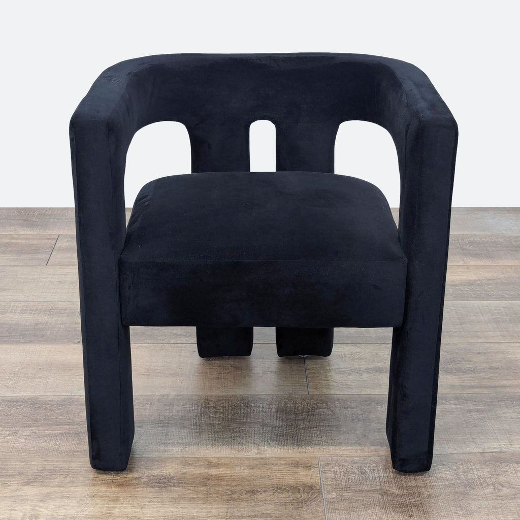 a pair of black velvet chairs