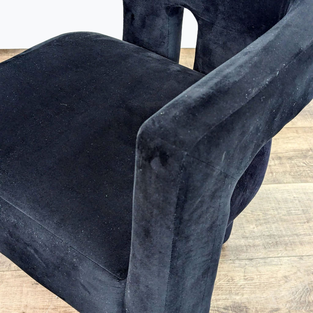 a pair of black velvet chairs