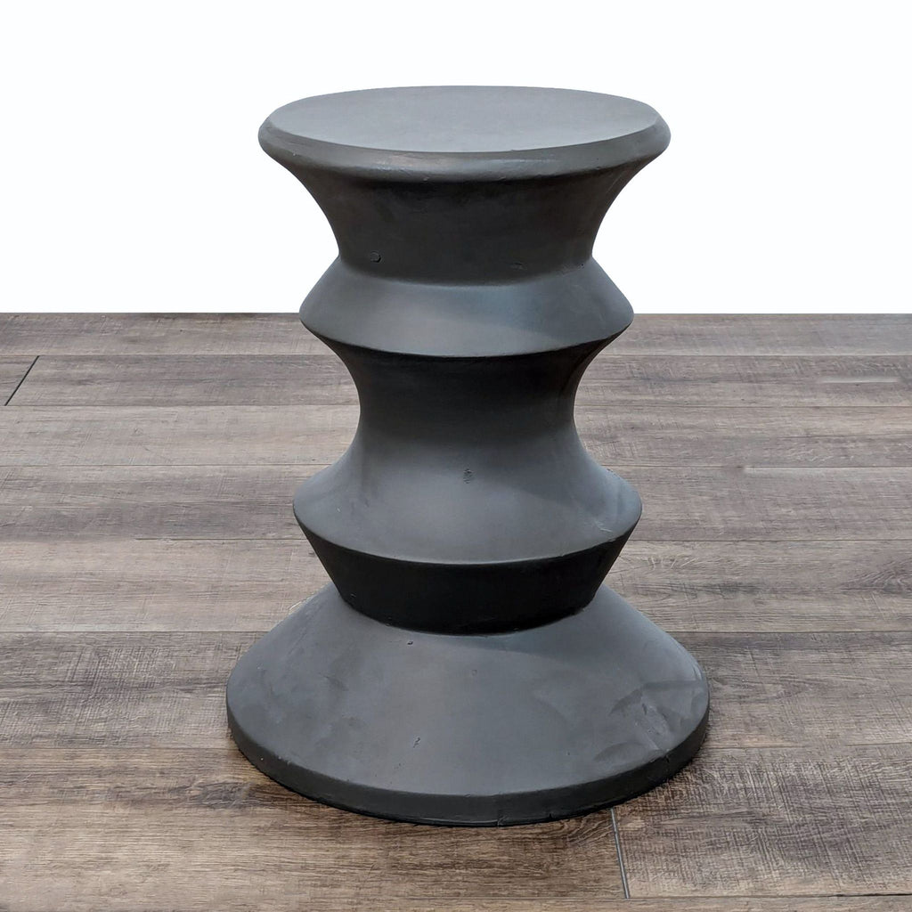 a black and white sculpture of three stacked black and white stacked stacked shapes.