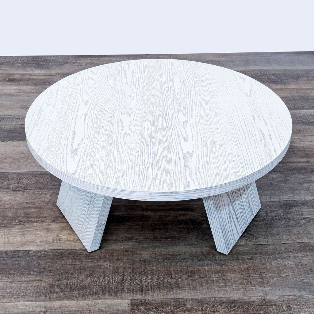 the coffee table is made from a white painted wood.