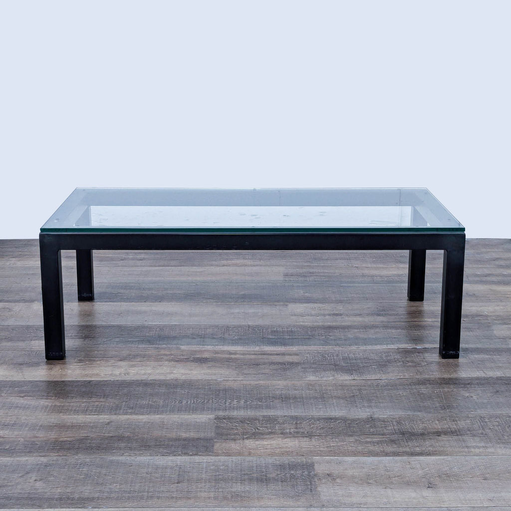 a large black glass coffee table with a glass top.