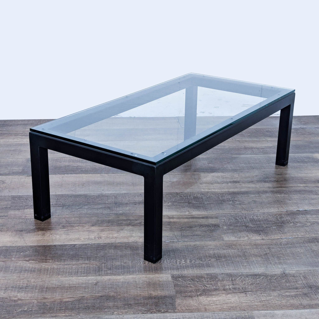 a black glass coffee table with a glass top.