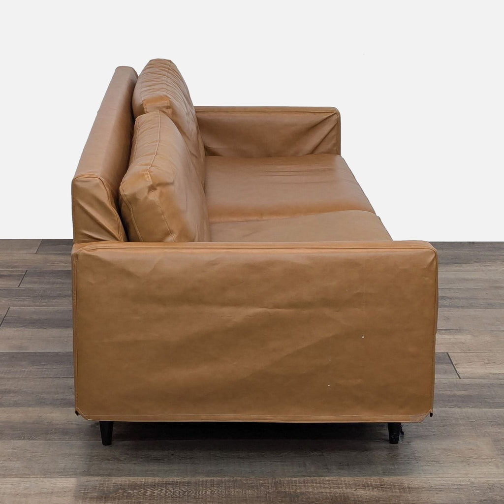 a pair of leather sofas in the style of [ unused0 ]