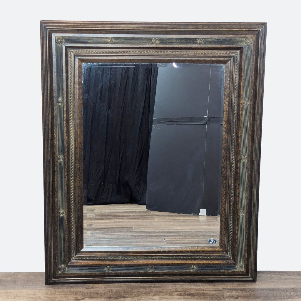 a large mirror with a dark brown frame.