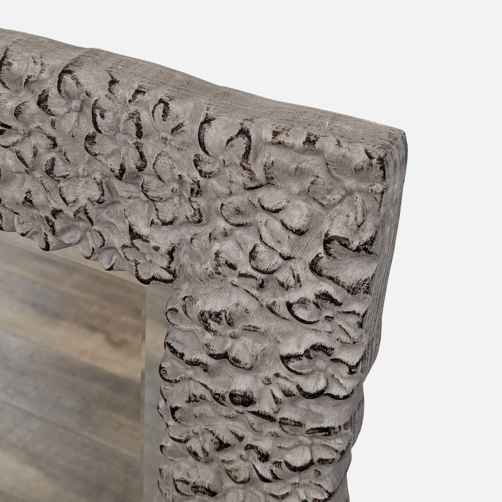 a hand carved wood bench with carved leaves