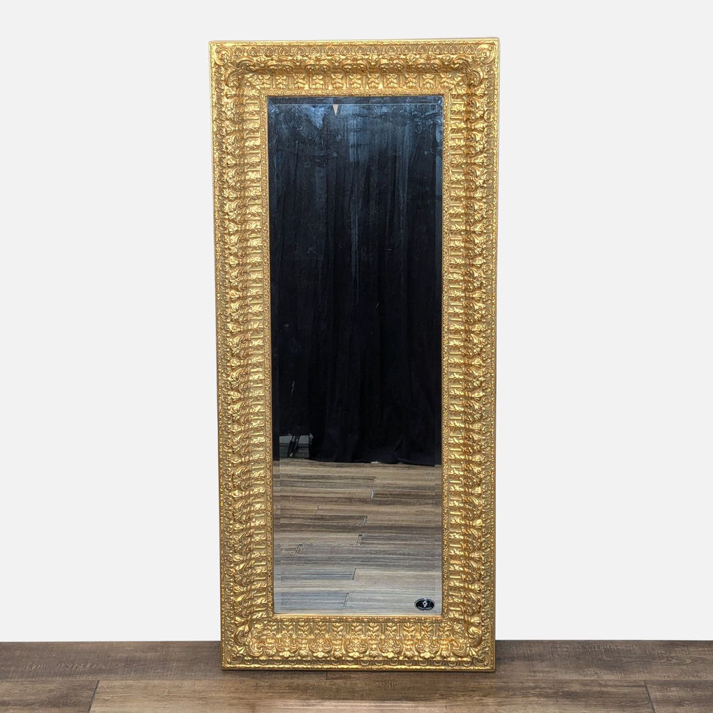 a large italian gilt mirror with a gold leafed frame.