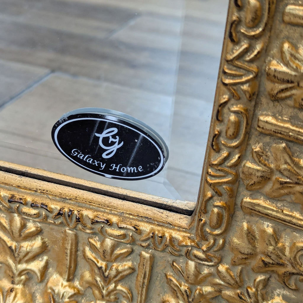 the mirror is a gold mirror with a black label.