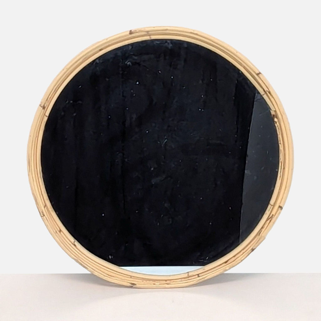 a large oval mirror with a black velvet frame.