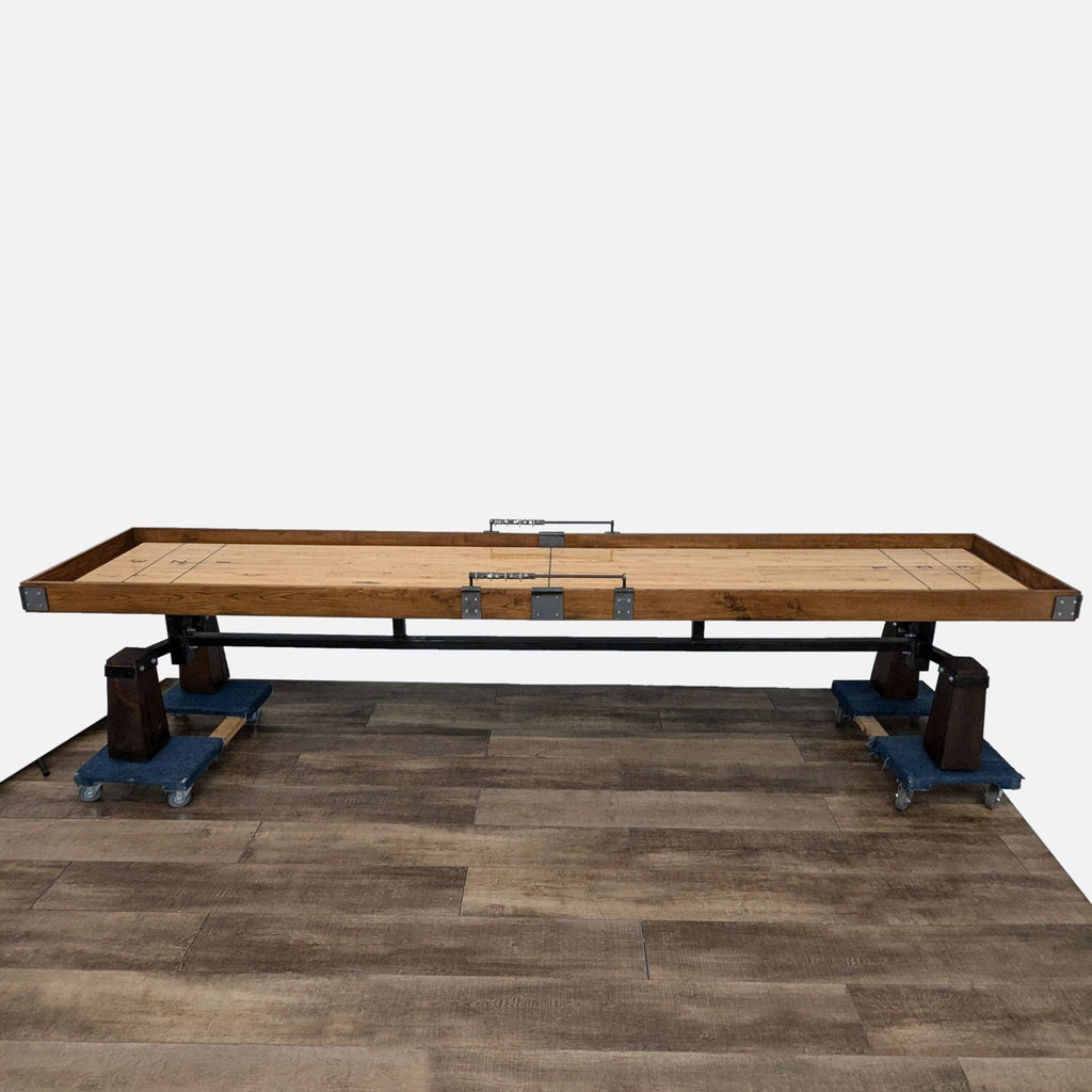 a large industrial table with a metal frame and a blue metal base.