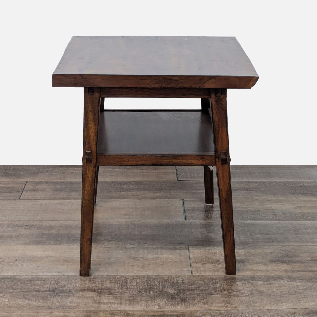 a small square table with a dark brown top and a dark brown leather seat.