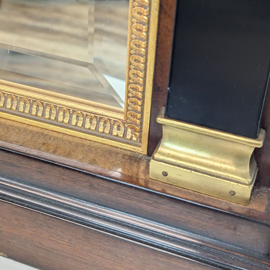 a large antique mirror with a gold leafed frame