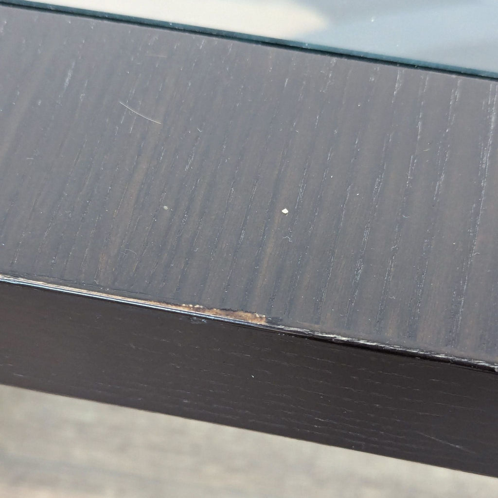 a close up of the top of a black metal outdoor table.