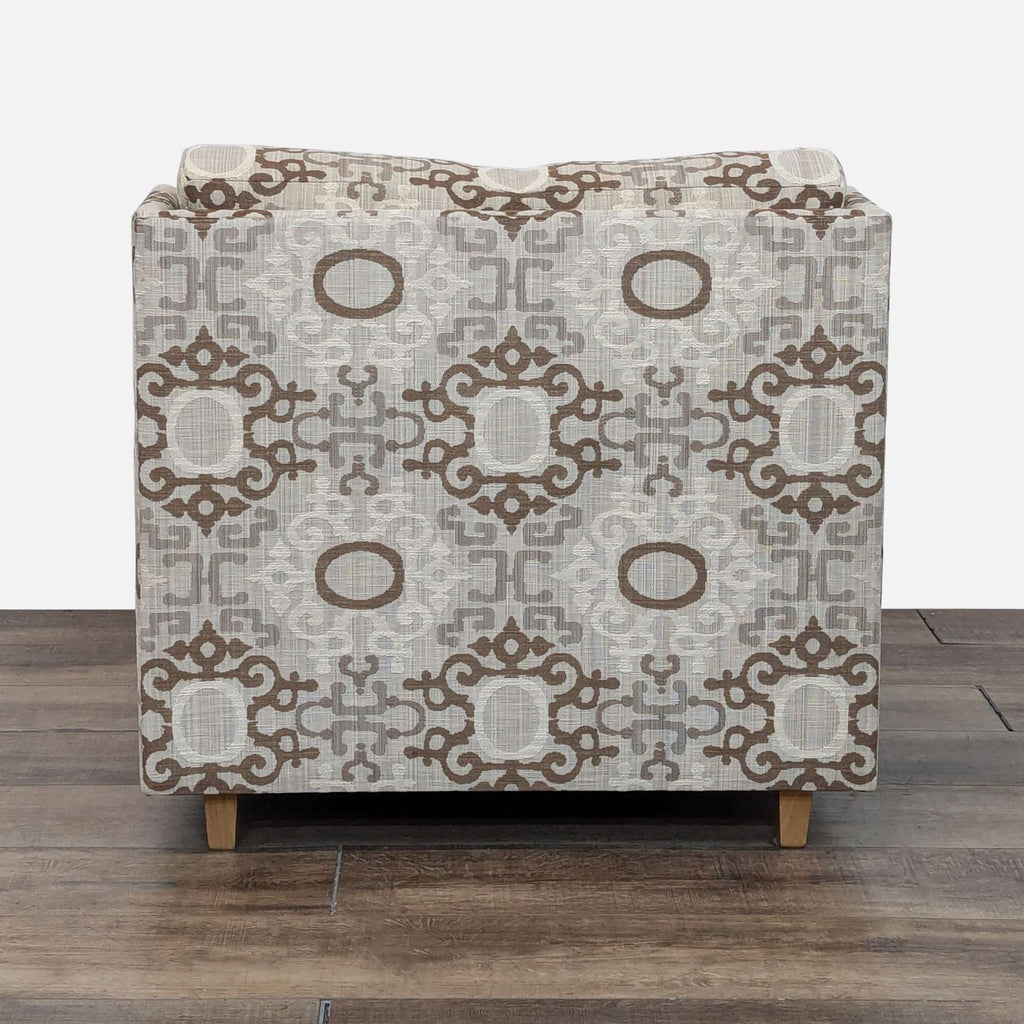 a close up of the ottoman in a beige and brown pattern.