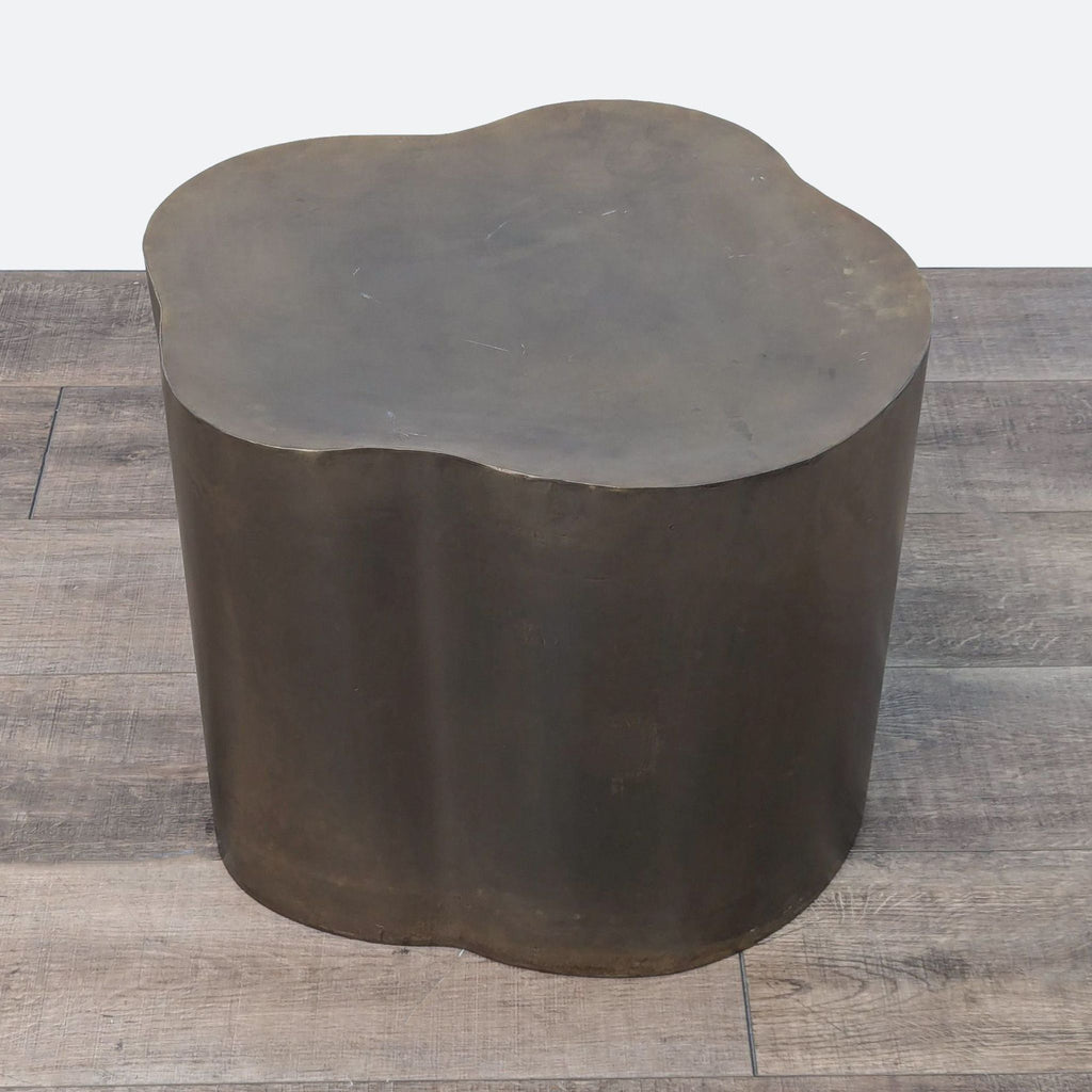 a large, circular, bronze, cast iron coffee table.