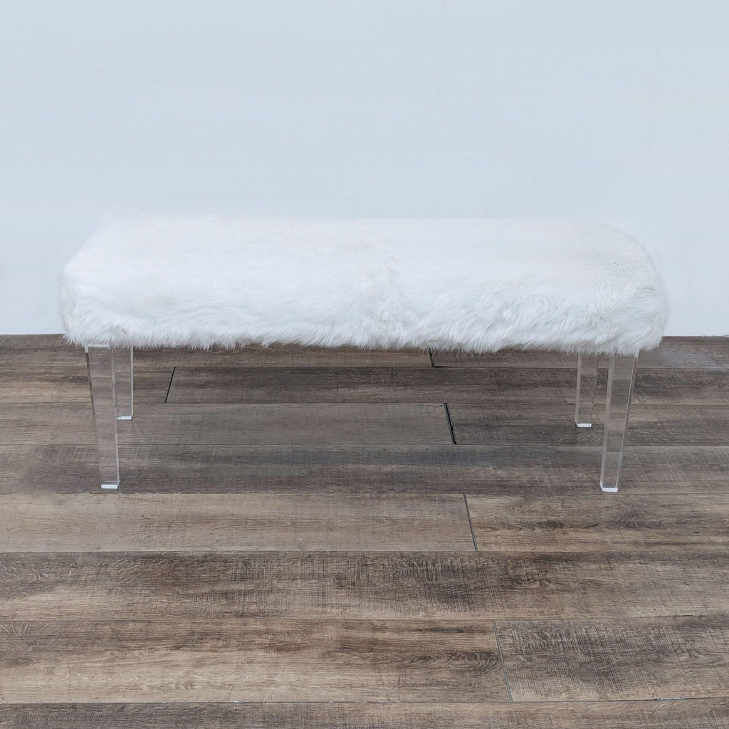 a white bench with a white fur seat.