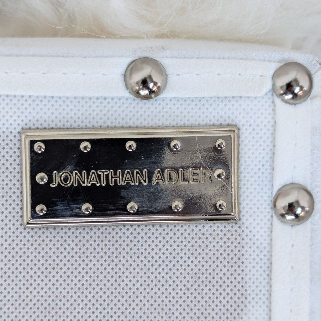 [ unused0 ] white leather [ unused0 ] purse with a silver metal name plate.