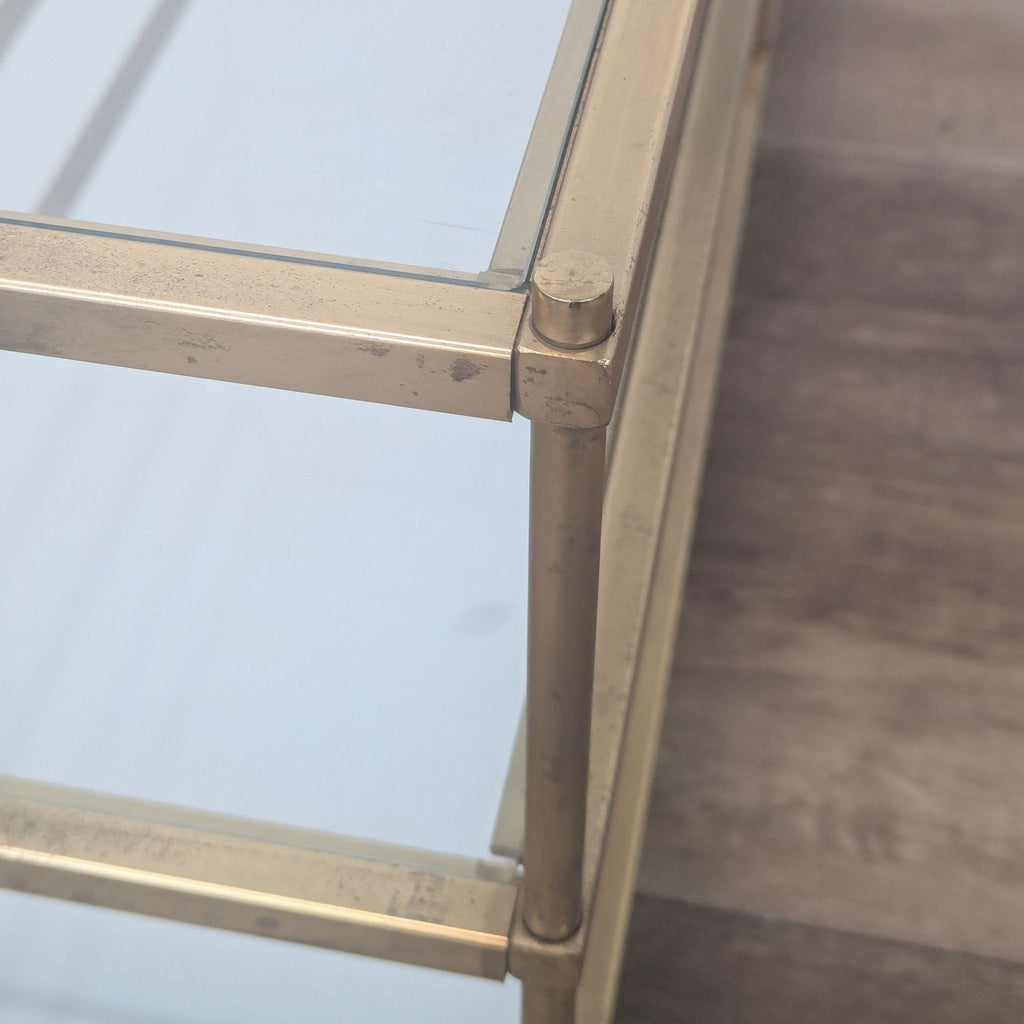 a pair of brass and glass coffee tables