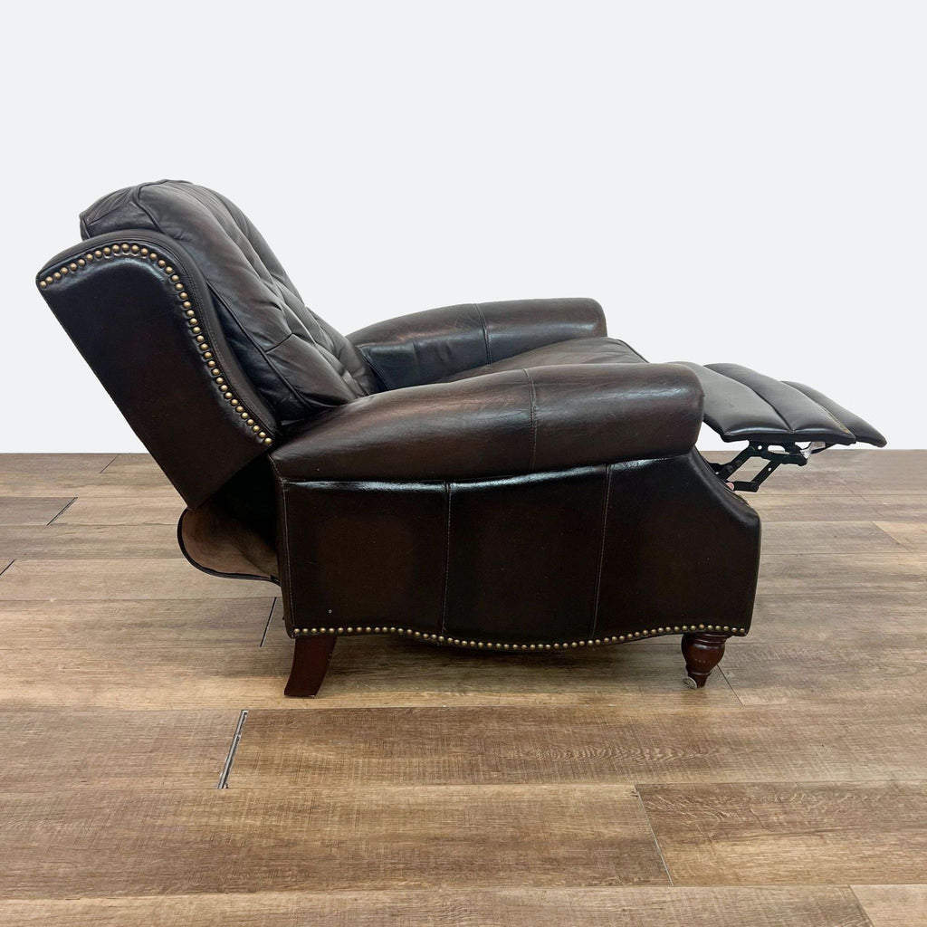 a leather reclining chair with a reclining back and foot rest.