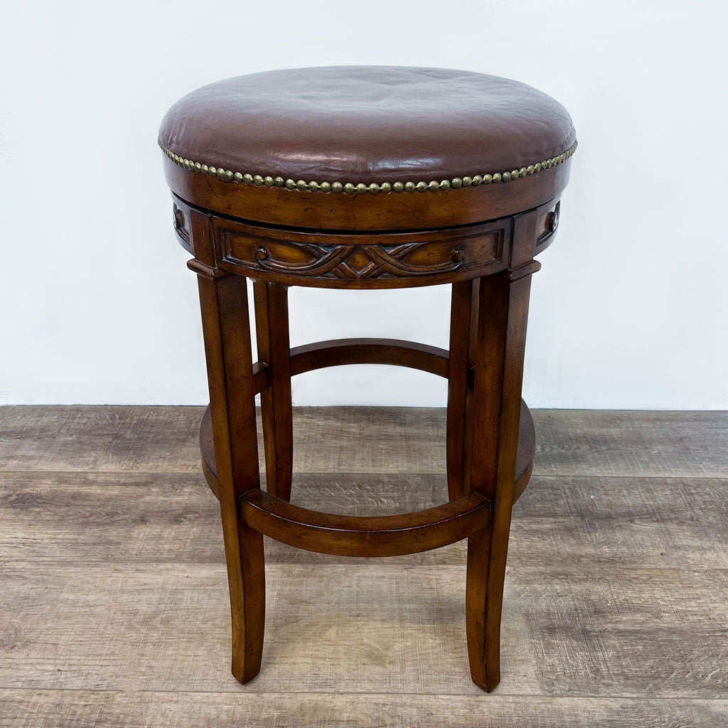 a vintage, round, leather, and leather stool.