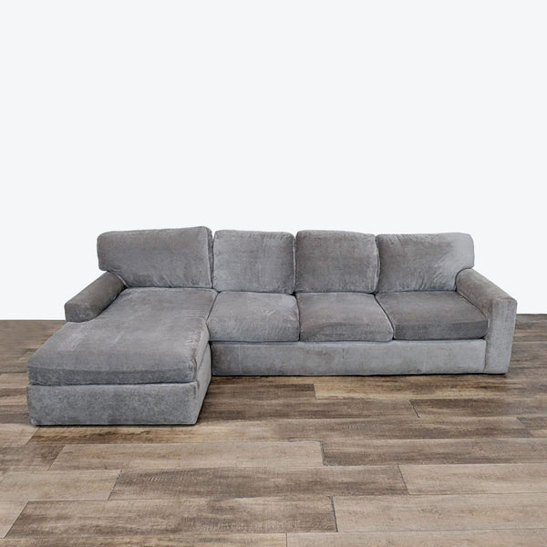 sofa in a grey color. the sofa is a modern design with a modern design. the sofa