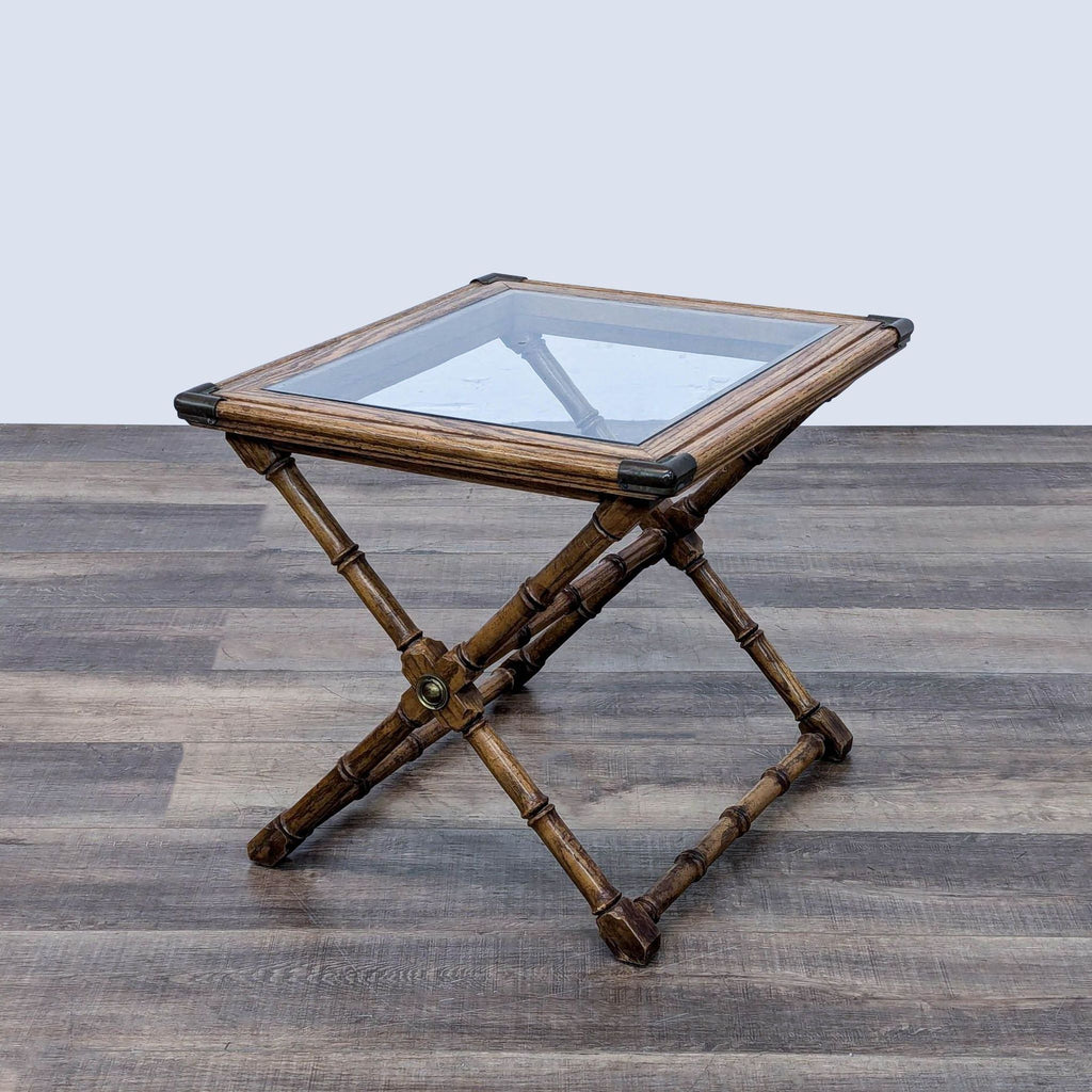 a bamboo side table with a glass top.