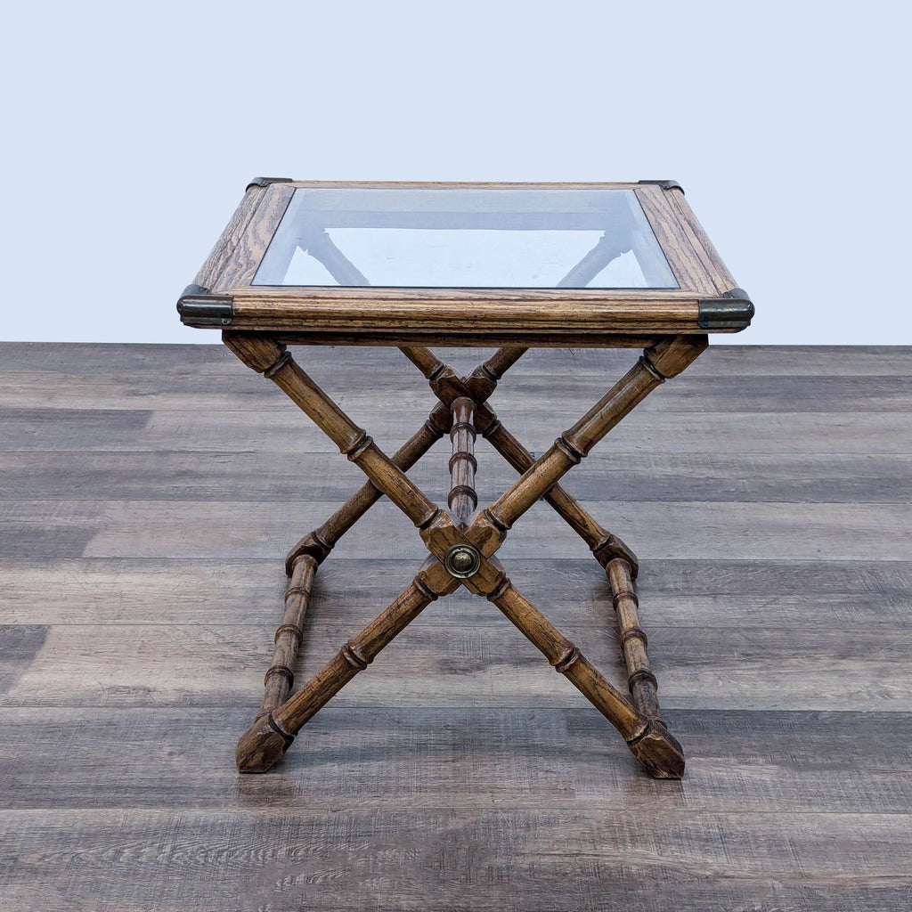 a small, rectangular, bamboo table with a glass top.