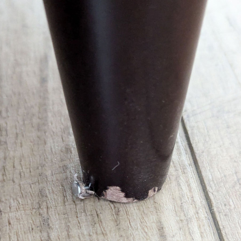 a close up of a coffee cup with a chipped edge